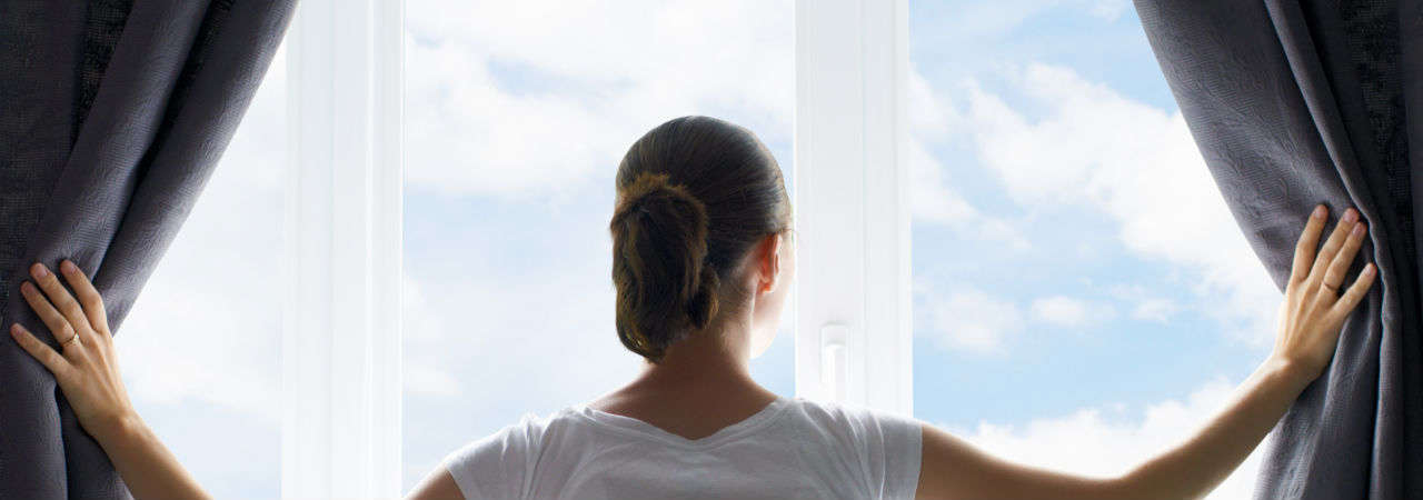 Image of woman looking out the window
